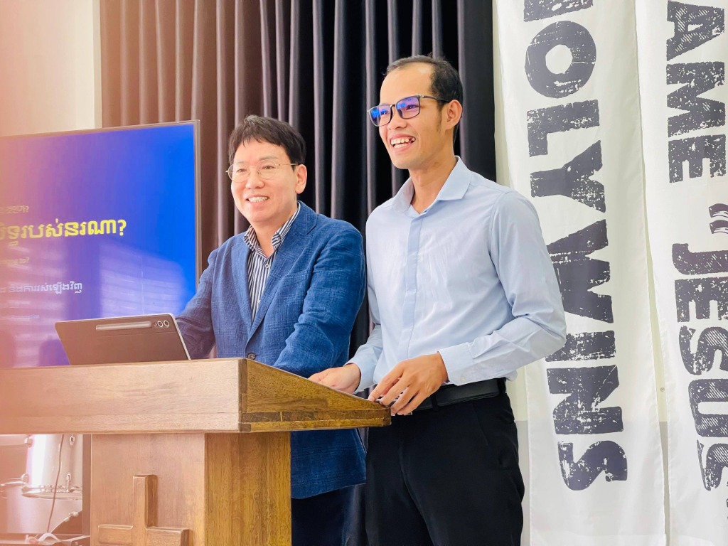 Pastor Kim Jong Ho and Leader Hun Chet preaching from the pulpit